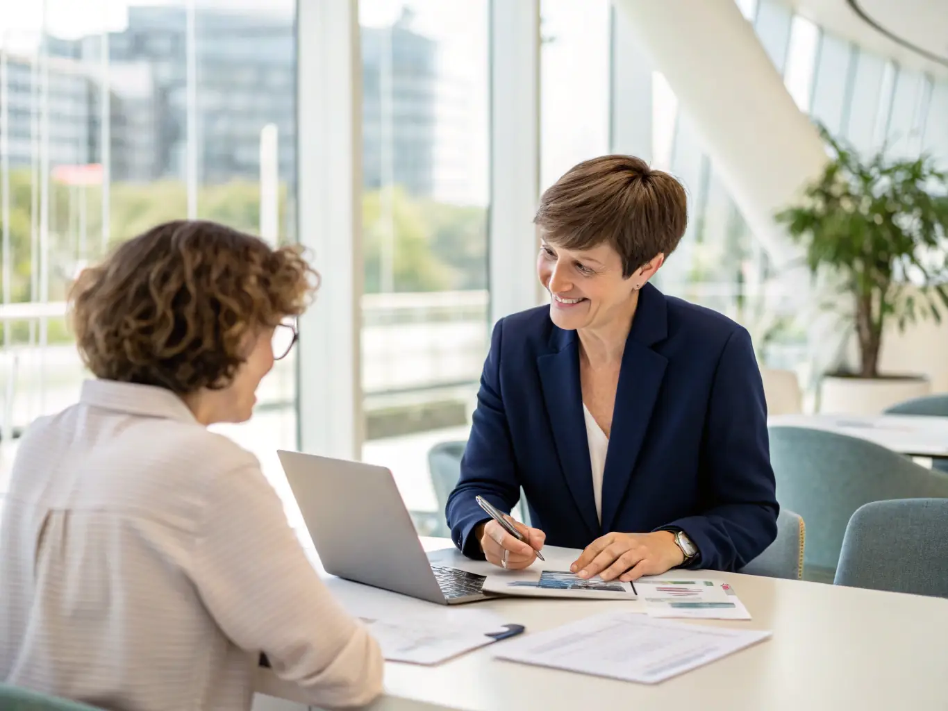 An image of a financial advisor meeting with a client in a modern office setting, reviewing financial documents and discussing future plans, with a focus on trust and personalized service.